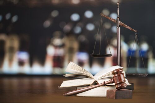 Scales, a gavel, and a law book lying on a desk in Dublin, GA. Personal Injury Lawyer